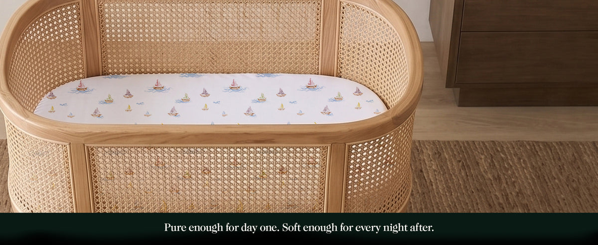 Rattan bassinet with organic cotton fitted sheet