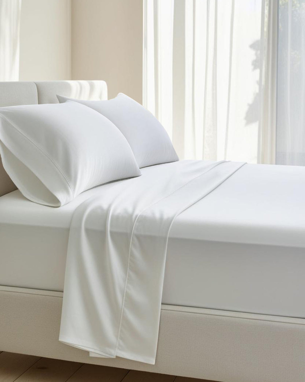 A bed made with white cotton percale sheets